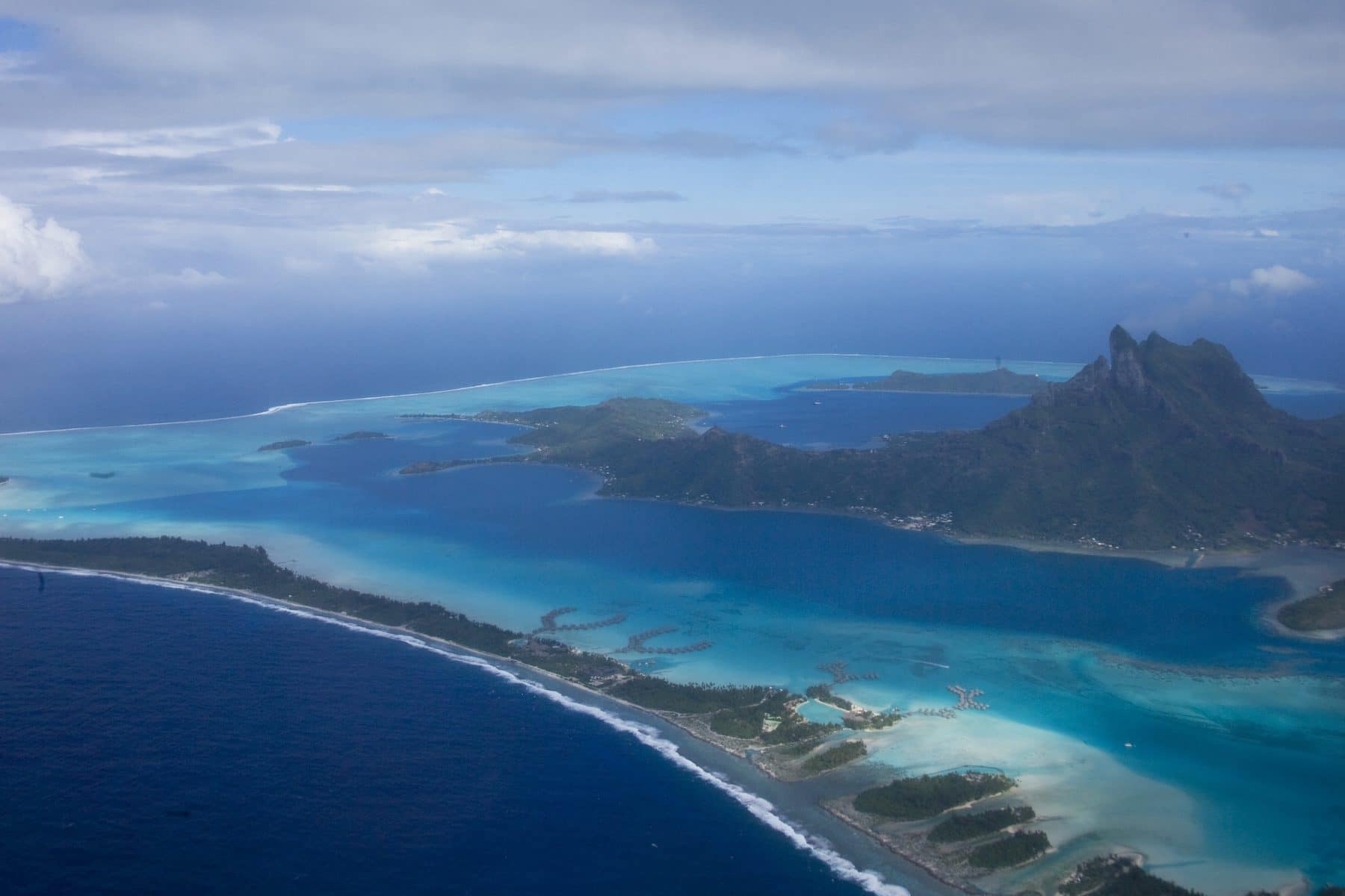 The lagoon of Bora Bora in shades of turquoise beneath Mount Otemanu