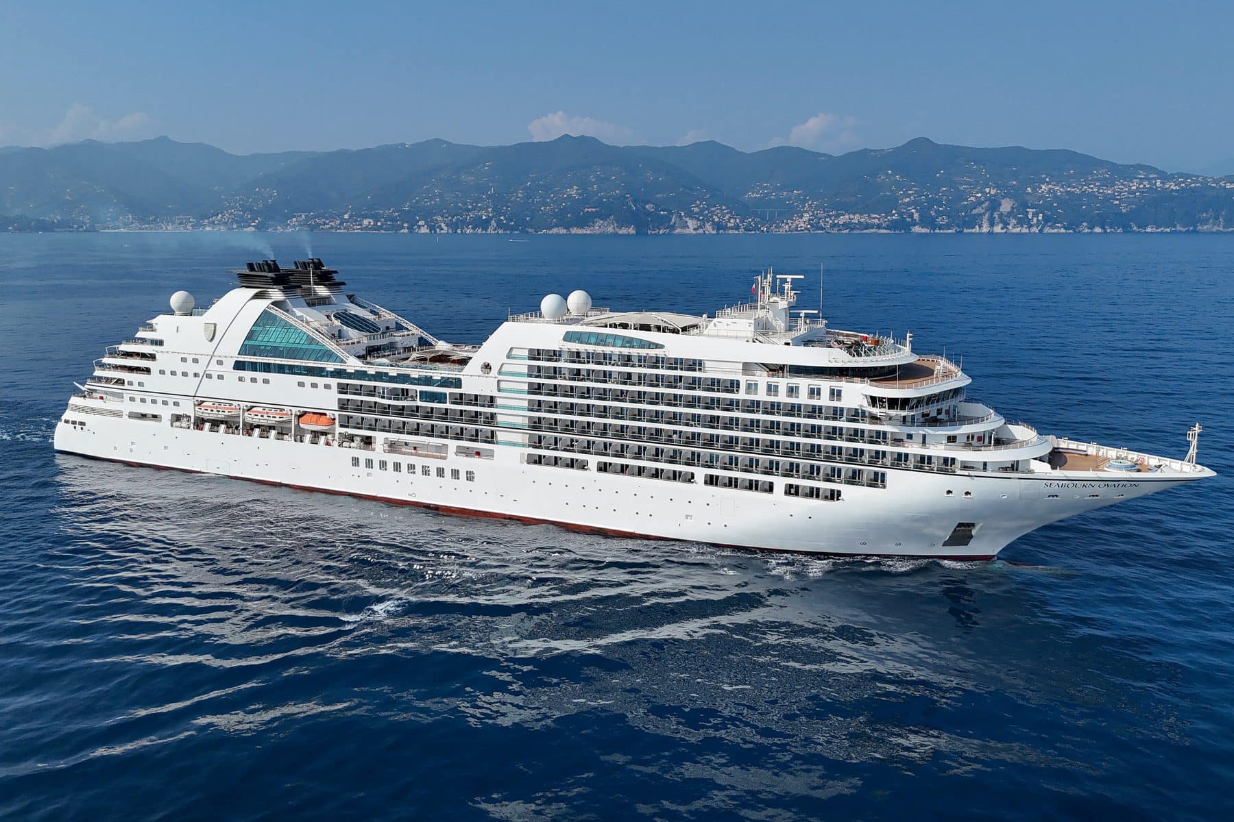 Seabourn Ovation at anchor off the pastel harbour front of Portofino, Italy