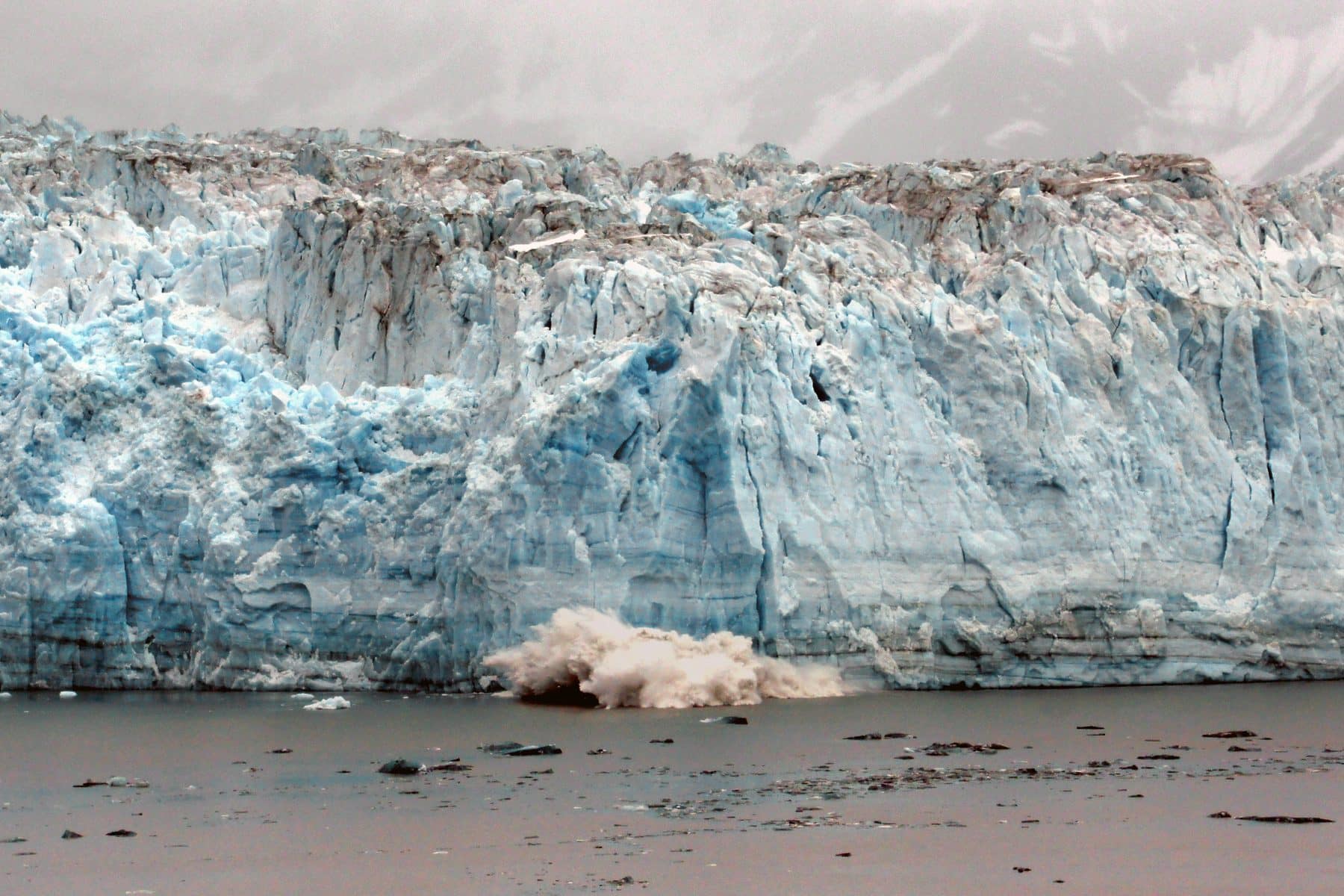 The blue face of Hubbard Glacier meeting the sea in Alaska