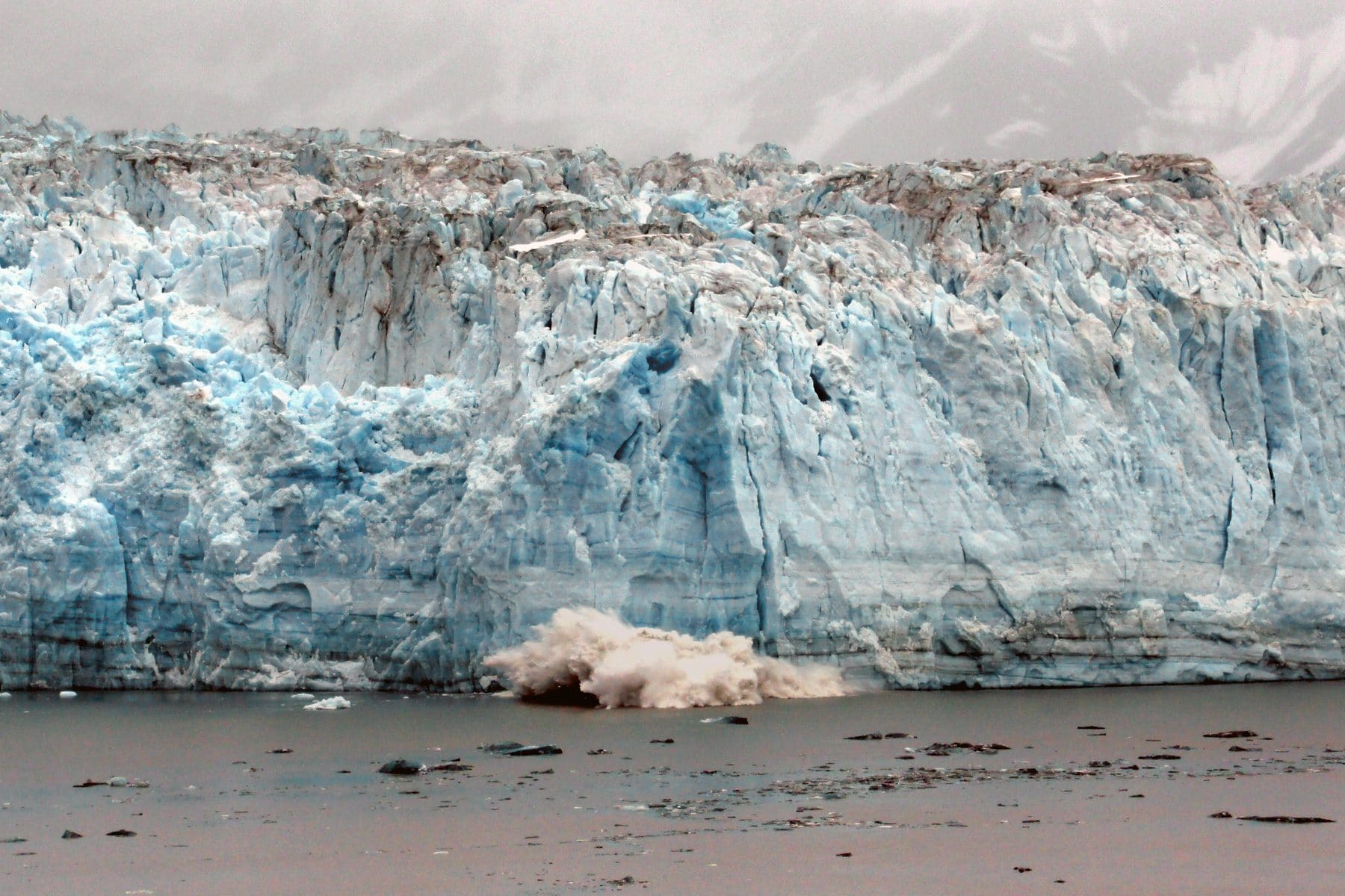 The blue face of Hubbard Glacier meeting the sea in Alaska