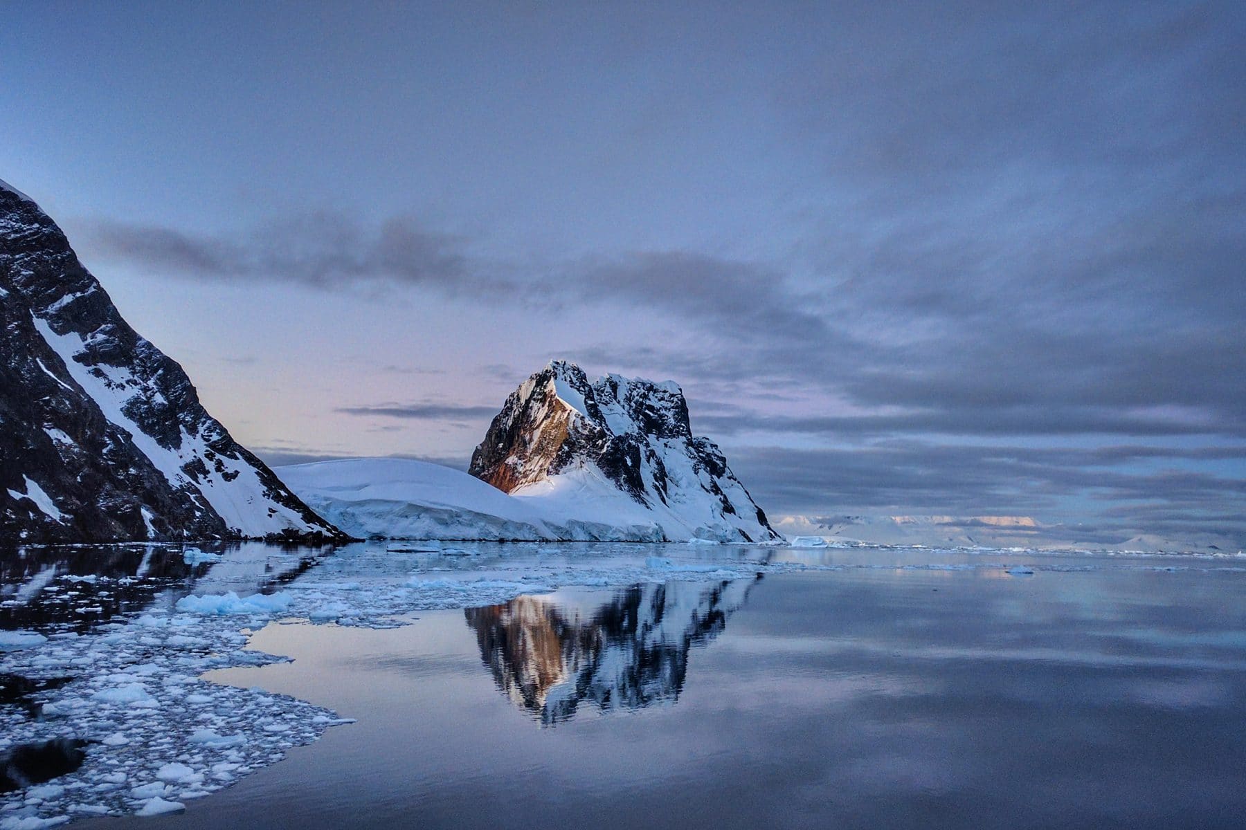 The Lemaire Channel, Antarctica, sheer rock and ice reflected in still water