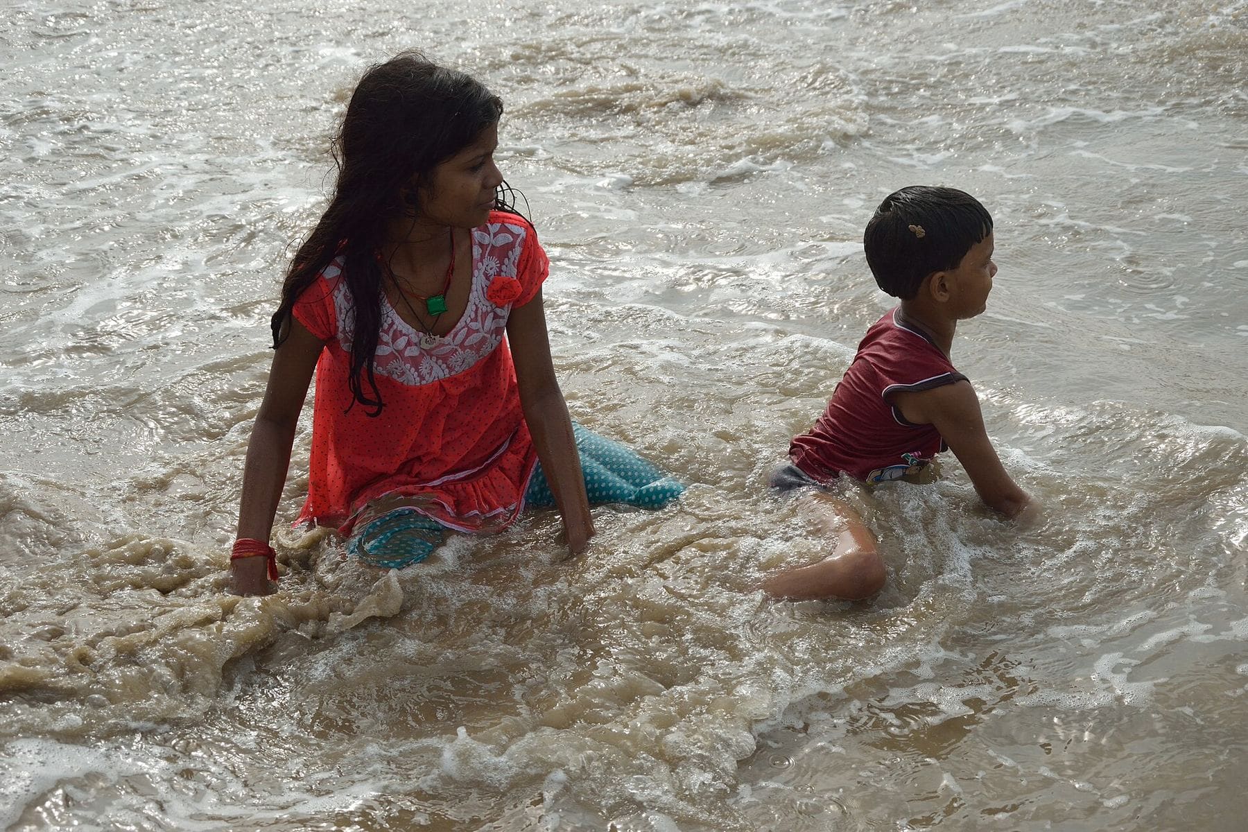 Children playing at the edge of the waves