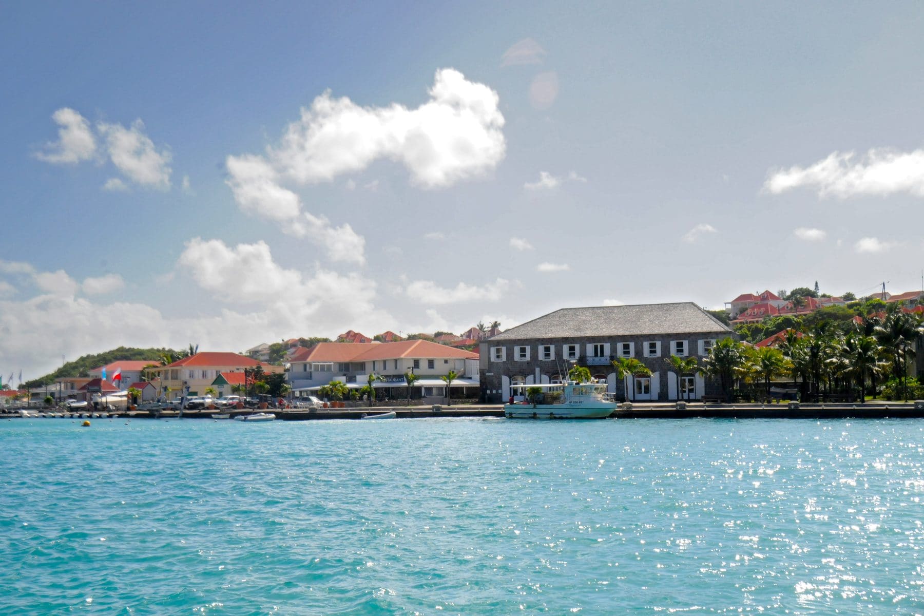 Approaching Gustavia harbor, St Barts, red roofs and yachts in the Caribbean