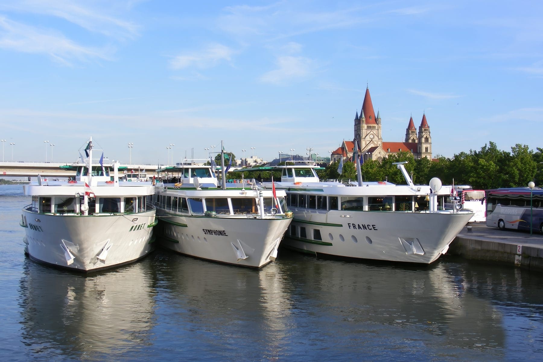 River cruise ships moored on the Danube in Vienna below the church of St Francis of Assisi