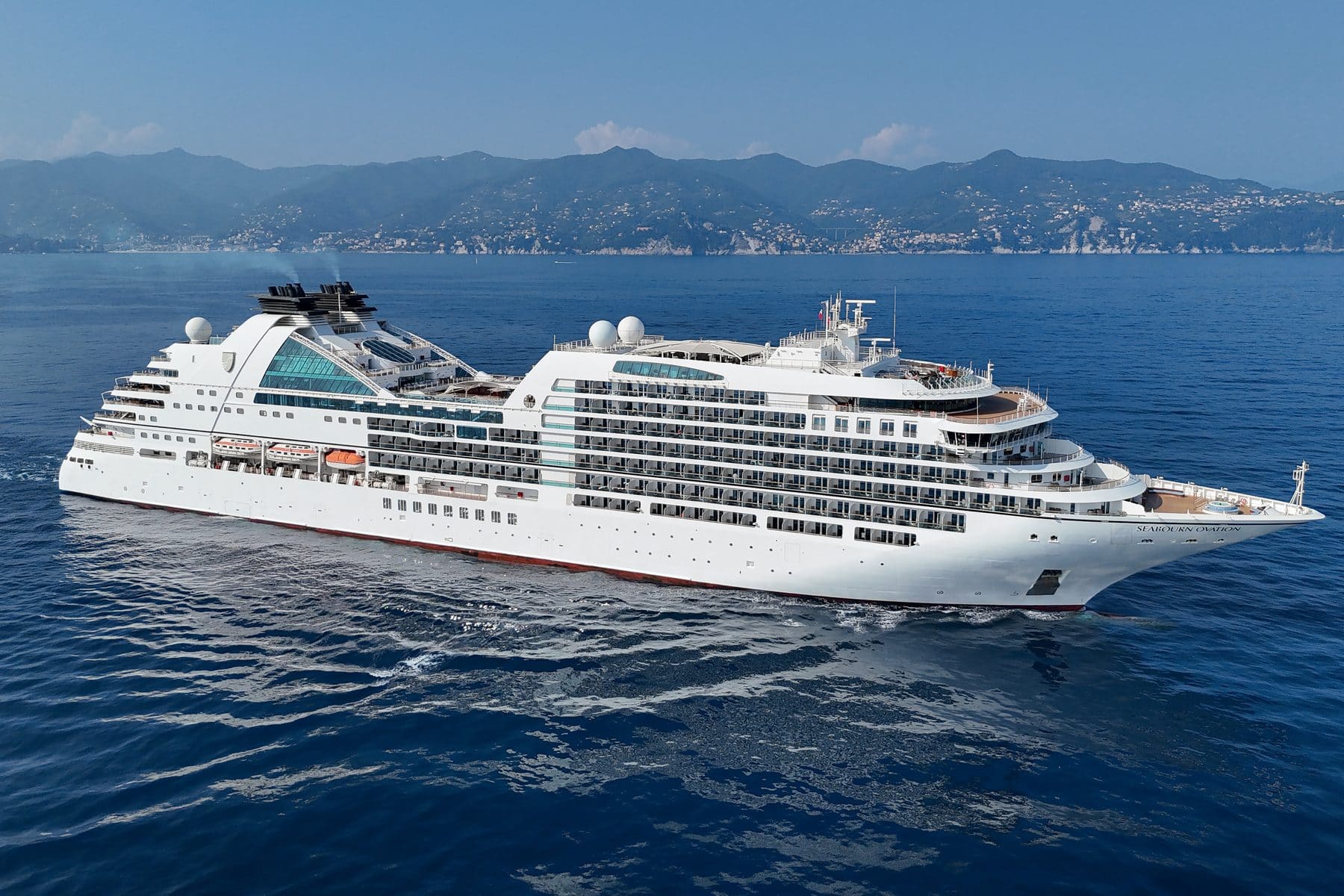 Seabourn Ovation at anchor off the pastel harbour front of Portofino, Italy