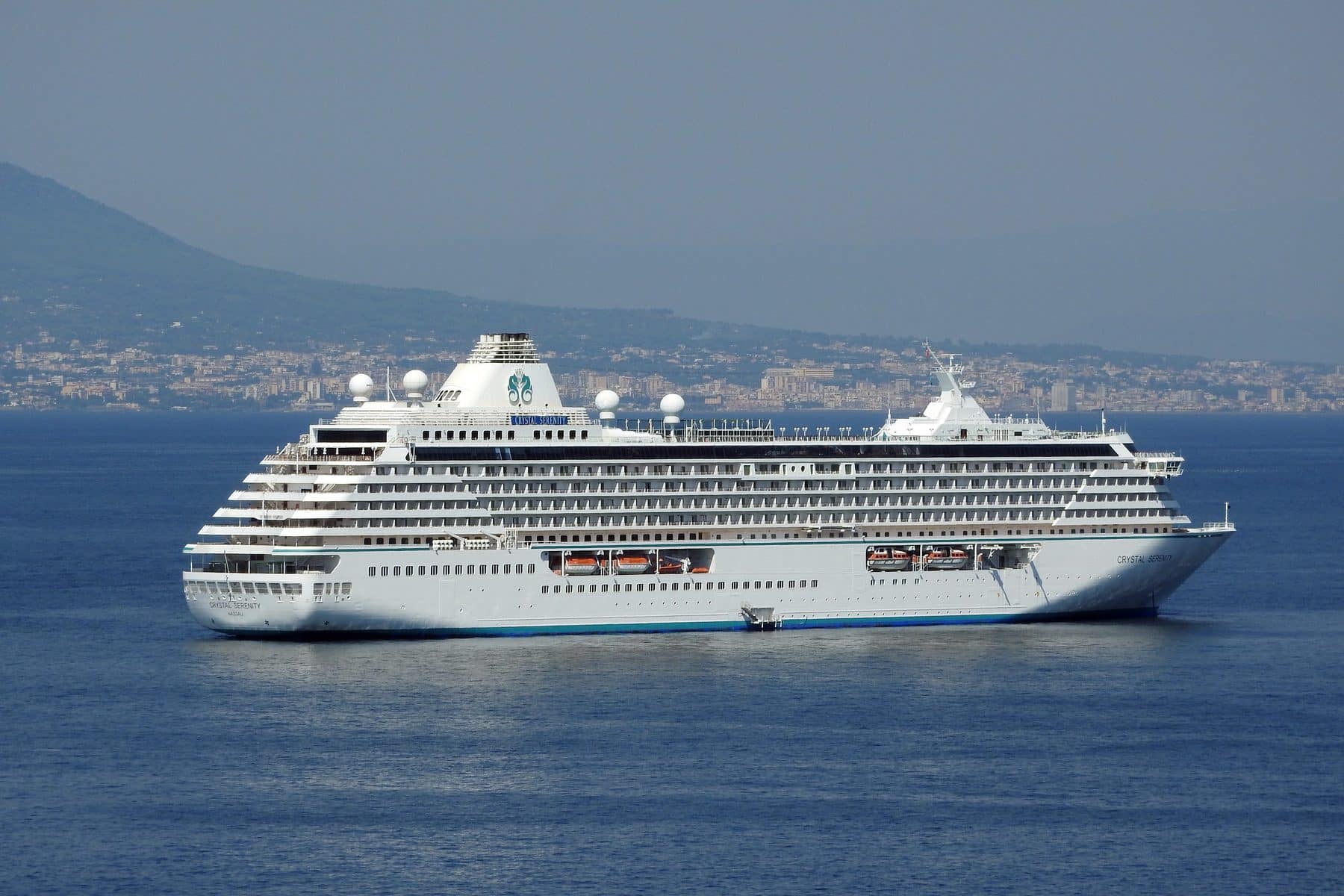 Crystal Serenity alongside in port, her white hull and tiered decks seen from the quay